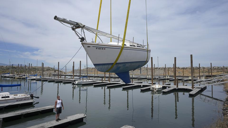 Sail boats are hoisted back into the Great Salt Lake Marina on June 6, 2023, in Magna, Utah. Sailors back out on the water are rejoicing after a snowy winter provided temporary reprieve. (AP Photo/Rick Bowmer)