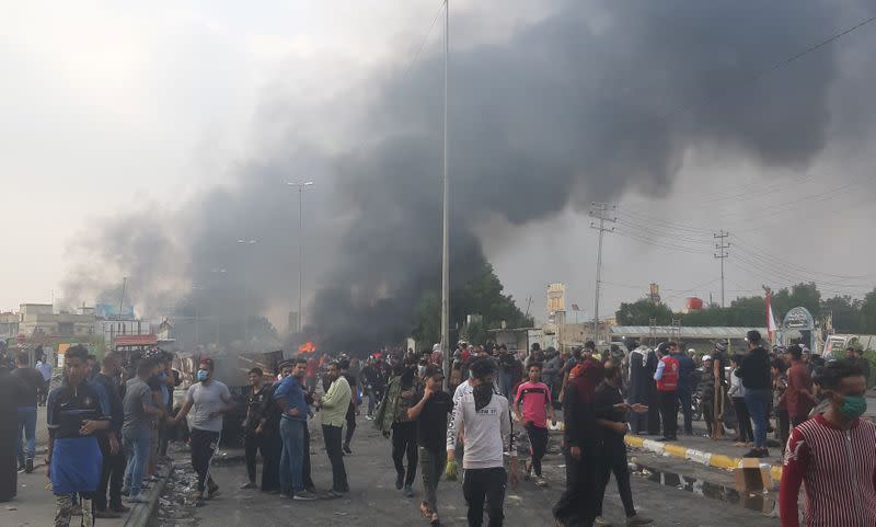 Smoke rises from burning vehicles of Iraqi security forces after clashes with protesters ongoing anti-government protests,in Nassiriya