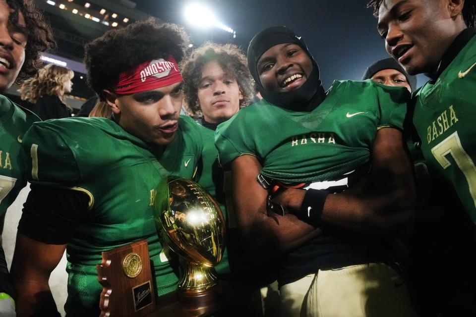 Dec 10, 2022; Tempe, AZ, USA; Basha's Miles Lockhart
 (1) holds the state championship trophy as he celebrates with his teammates after their 28-21 win over Saguaro during their Open Division State Championship at ASU Sun Devil Stadium.