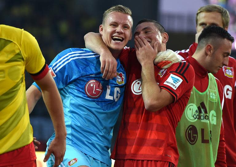 Leverkusen's goalkeeper Bernd Leno (L) and defender Kyriakos Papadopolous celebrate after their German first division Bundesliga match against Borussia Dortmund, in Dortmund, western Germany, on August 23, 2014