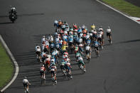 The peloton makes a turn during the men's cycling road race at the 2020 Summer Olympics, Saturday, July 24, 2021, in Oyama, Japan. (AP Photo/Thibault Camus)