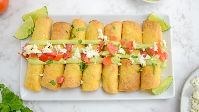 taquitos with sauce and toppings