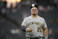 Milwaukee Brewers first baseman Daniel Vogelbach heads to his position in the fifth inning of a baseball game against the Colorado Rockies, Thursday, June 17, 2021, in Denver. (AP Photo/David Zalubowski)