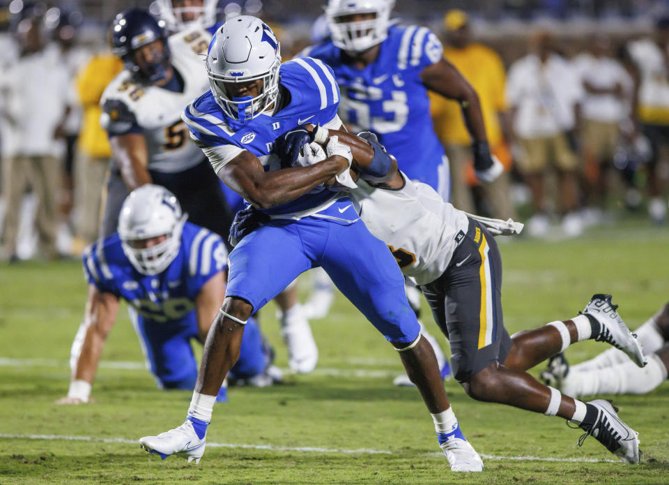 Duke's Jaylen Coleman, left, carries the ball for a touchdown past North Carolina A&T's Joseph Stuckey, right, during the second half of an NCAA college football game in Durham, N.C., Saturday, Sept. 17, 2022. (AP Photo/Ben McKeown)