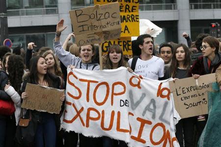 French high students shout slogans as they stand behind a banner which reads in part, "Stop Expulsions", during a demonstration in Paris October 18, 2013. Students blocked schools and demonstrate for a second day to protest over the expulsion of a 15-year-old Kosovar schoolgirl, Leonarda Dibrani, who was arrested by police during a school trip and deported to Kosovo, and also in support of another deported student of Armenian descent, Khatchik Kachatryan. REUTERS/Gonzalo Fuentes