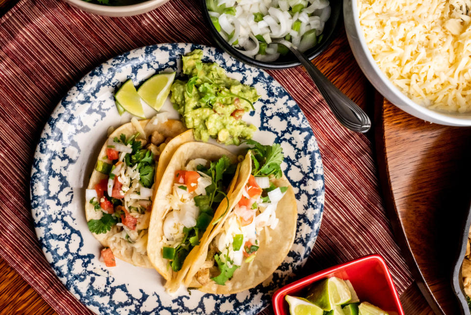 A plate of tacos with guacamole.