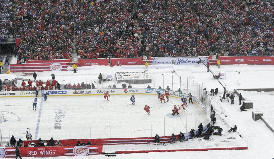 The Toronto Maple Leafs and the Detroit Red Wings play during the first period of the Winter Classic outdoor NHL hockey game at Michigan Stadium in Ann Arbor, Mich., Wednesday, Jan. 1, 2014. (AP Photo/Carlos Osorio)