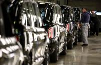 A worker walks along the TX electric taxi production line inside the LEVC (London Electric Vehicle Company) factory in Coventry