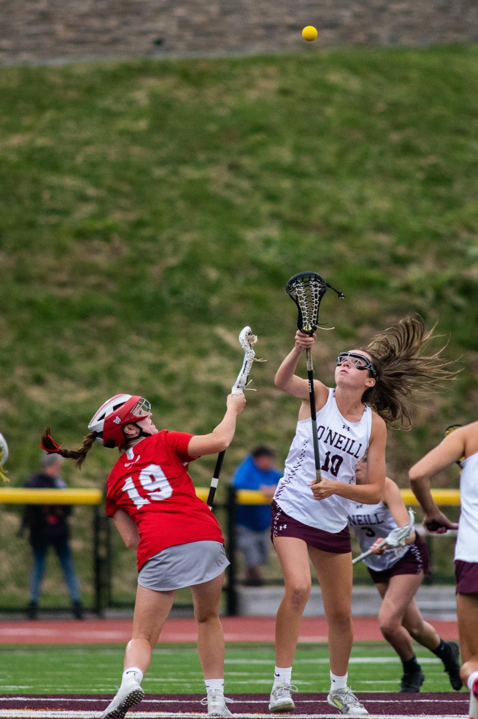 Red Hook's Yianna Giannoulis, left, and O'Neill's Bella Alberici, right, go for the ball on a draw during the Section 9 Class D girls lacrosse final on May 26, 2022.