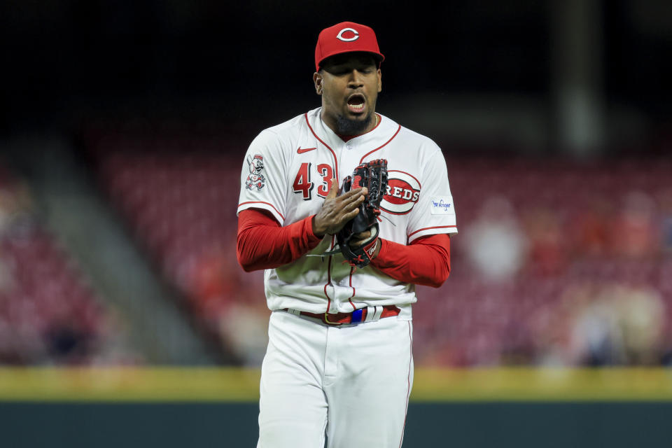 Cincinnati Reds' Alexis Diaz slaps his glove as he walks to the dugout during the eighth inning of a baseball game against the New York Mets in Cincinnati, Tuesday, May 9, 2023. The Reds won 7-6. (AP Photo/Aaron Doster)