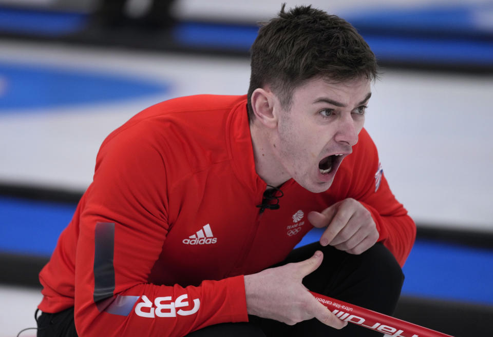 Britain's Grant Hardie, directs his teammate, during the men's curling match against Italy, at the 2022 Winter Olympics, Thursday, Feb. 10, 2022, in Beijing. (AP Photo/Nariman El-Mofty)