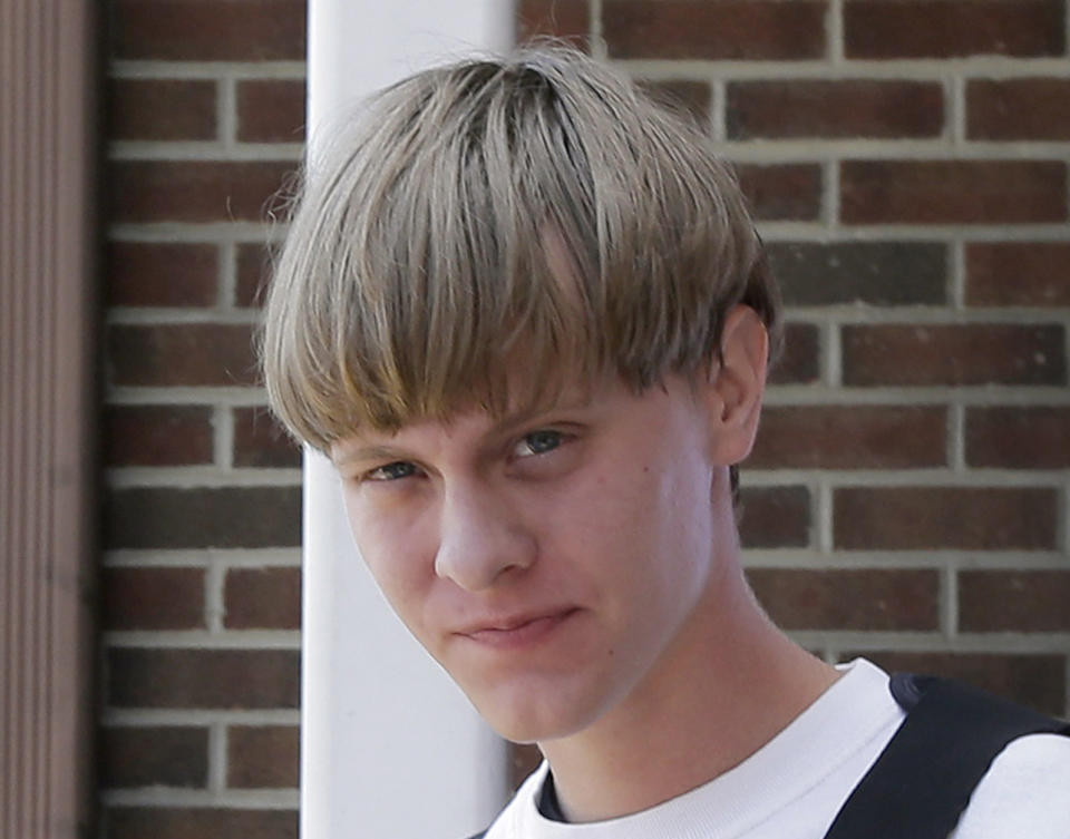 Charleston, S.C., shooting suspect Dylann Storm Roof is escorted from the Sheby Police Department  in Shelby, N.C., Thursday, June 18, 2015.  Roof is a suspect in the shooting of several people Wednesday night at the historic The Emanuel African Methodist Episcopal Church in Charleston, S.C. (AP Photo/Chuck Burton)