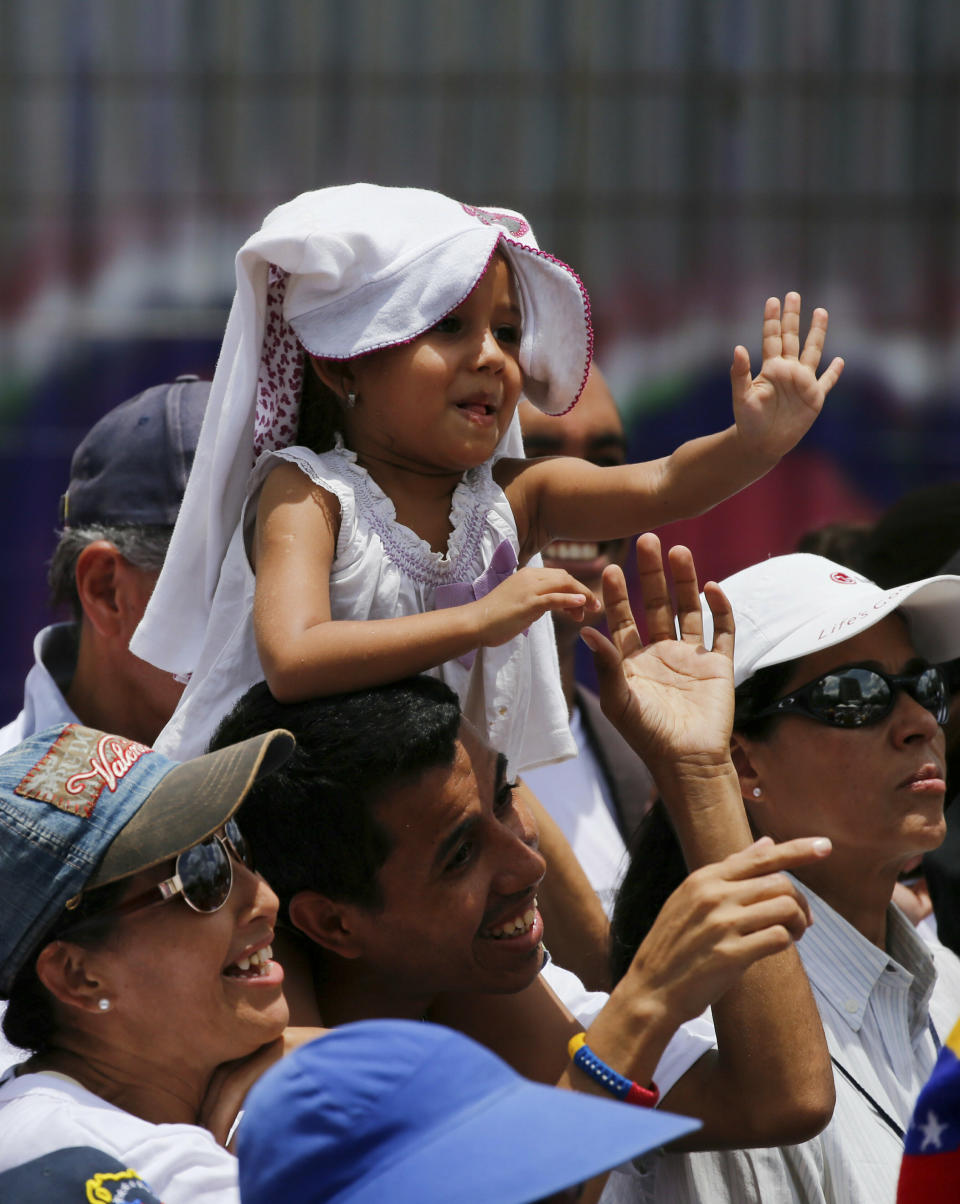 Supporters of Venezuela's opposition leader and self proclaimed president Juan Guaido, cheers him during a rally in Caracas, Venezuela, Saturday, April 27, 2019. The Trump administration has added Venezuelan Foreign Minister Jorge Arreaza to a Treasury Department sanctions target list as it increases pressure on Guaido's opponent, embattled President Nicolas Maduro. (AP Photo/Fernando Llano)