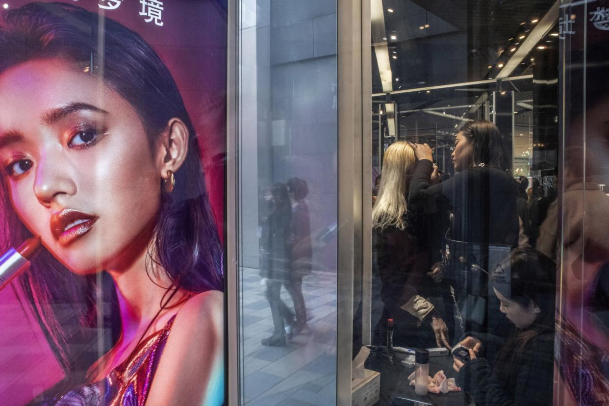 Customers try on make-up at a MAC Cosmetics store in Beijing, China. (Photo: Gilles Sabrie/Bloomberg)