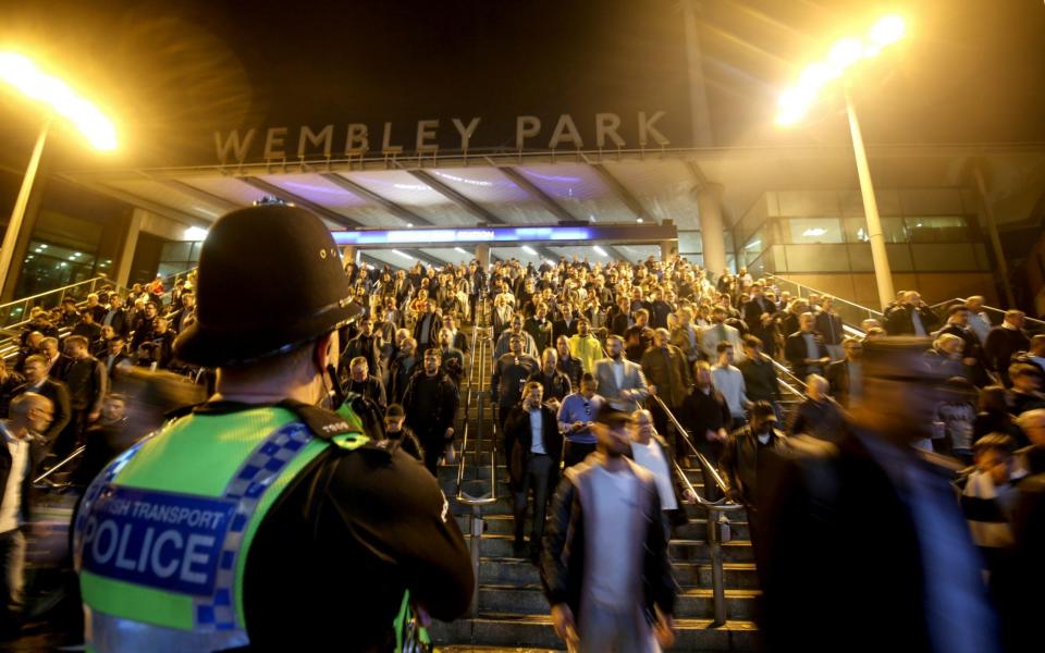 A general and abstract view of police standing vigil as fans coming down the steps at Wembley Park station  - Getty Images