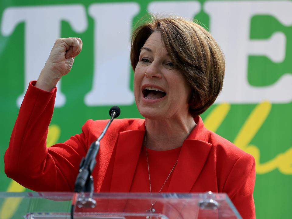 Senator Amy Klobuchar poses triumphantly.