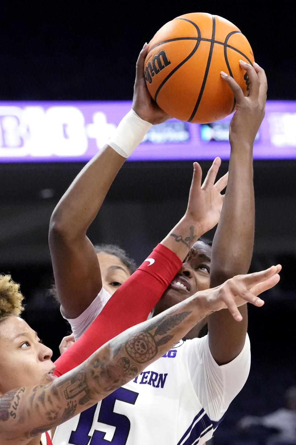 Northwestern forward Courtney Shaw, right, rebounds a ball against Ohio State guard Rikki Harris during the first half of an NCAA college basketball game Wednesday, Dec. 28, 2022, in Evanston, Ill. (AP Photo/Nam Y. Huh)