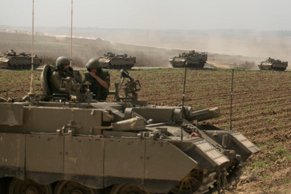 Israeli armor personnel carrier move in formation near the border with Gaza on October 14, 2023 in Near Sderot, Israel. (Getty Images)