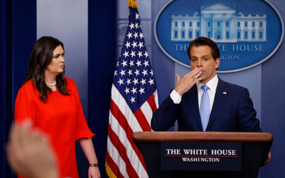 New White house communications director Anthony Scaramucci, flanked by Sarah Huckabee Sanders, blows a kiss to reporters after addressing them on his first day on the job - Credit: Jonathan Ernst/Reuters