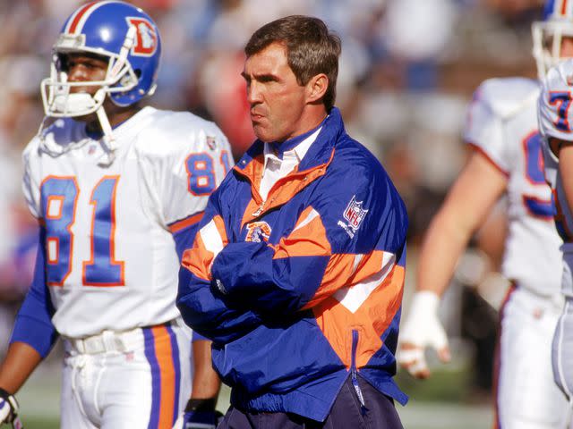 <p>George Rose/Getty</p> Mike Shanahan of the Denver Broncos watches the action from the sidelines during a game against the Oakland Raiders on December 24, 1995 in Oakland, California.
