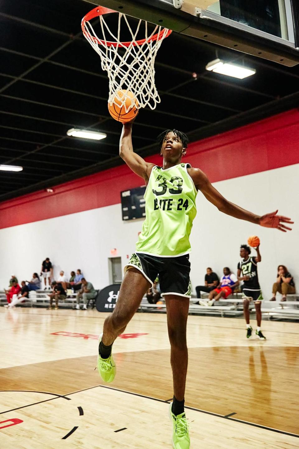 Class of 2025 Kentucky men’s basketball recruit Caleb Wilson goes to dunk the ball during the Under Armour Next Elite 24 event in August 2023 at the CORE4 Atlanta facility in Chamblee, Georgia. Wilson said he will be taking an official visit to UK this fall.