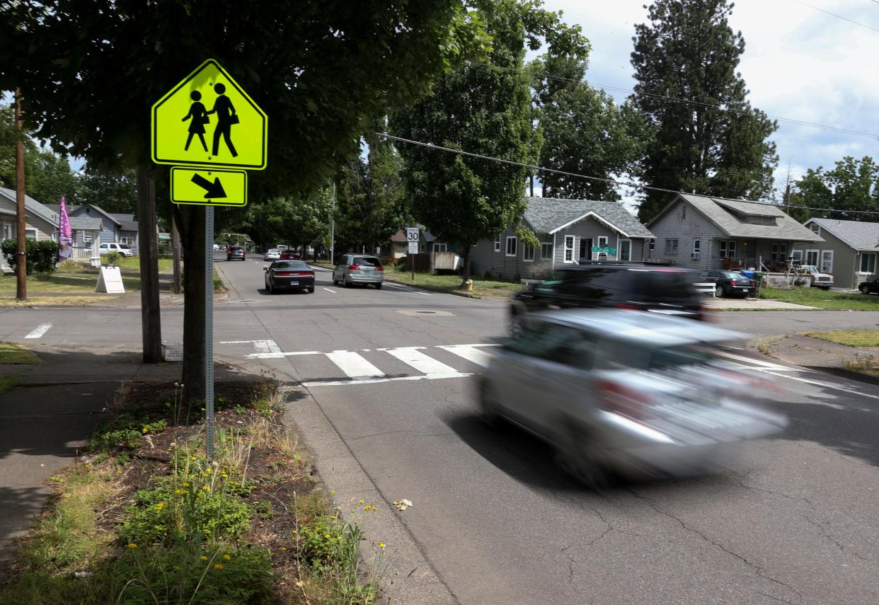 Traffic drives past a crosswalk on Liberty Street NE.