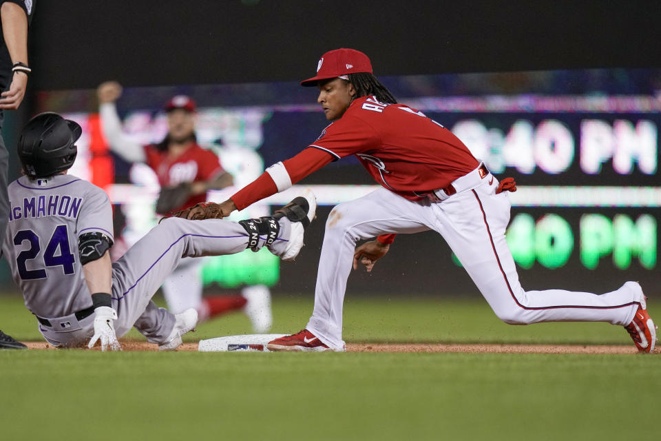 Colorado Rockies' Ryan McMahon is tagged out at second base by Washington Nationals shortstop CJ Abrams after McMahon hit a single and tried to reach second during the first inning of a baseball game at Nationals Park, Tuesday, July 25, 2023, in Washington. (AP Photo/Alex Brandon)