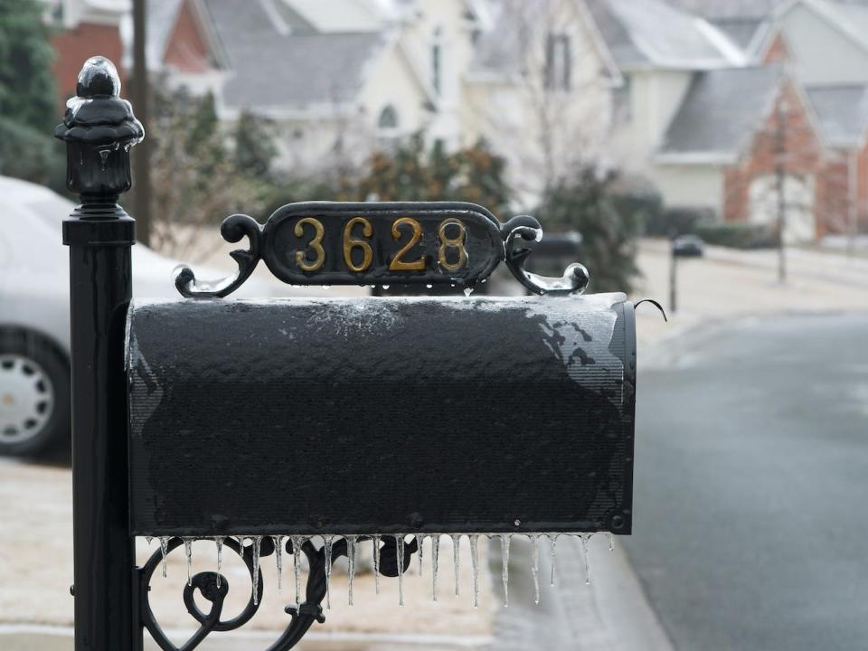 An image of a frozen mailbox with a visible house number.