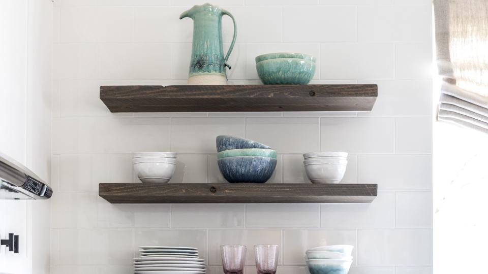 kitchen with open shelving displaying dishes