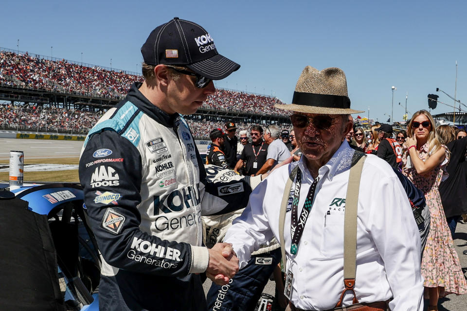 Brad Keselowski, left, talks with Jack Rousch before a NASCAR Cup Series auto race Sunday, Oct. 2, 2022, in Talladega, Ala. (AP Photo/Butch Dill)