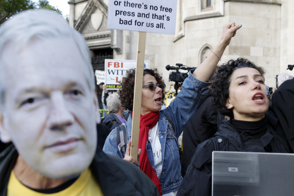 Julian Assange supporters demonstrate outside the High Court in London, Thursday, Oct. 28, 2021. The U.S. government is this week asking Britain's High Court to overturn a judge's decision that WikiLeaks founder Julian Assange should not be sent to the United States to face espionage charges. A lower court judge refused extradition in January on health grounds, saying Assange was likely to kill himself if held under harsh U.S. prison conditions. (AP Photo/David Cliff)