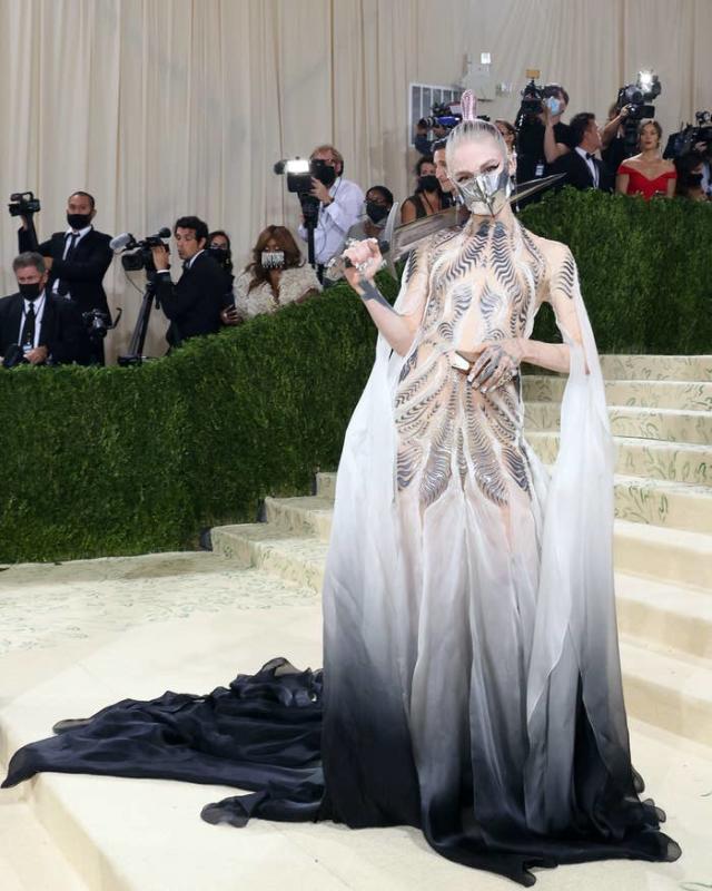 White winged dress worn by Grimes in her Player Of Games Official Music  Video