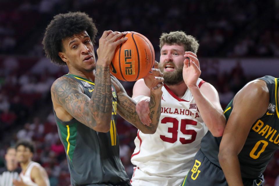 Baylor forward Jalen Bridges (11) grabs a rebound beside Oklahoma forward Tanner Groves (35) during the Bears' 62-60 win Saturday in Norman.