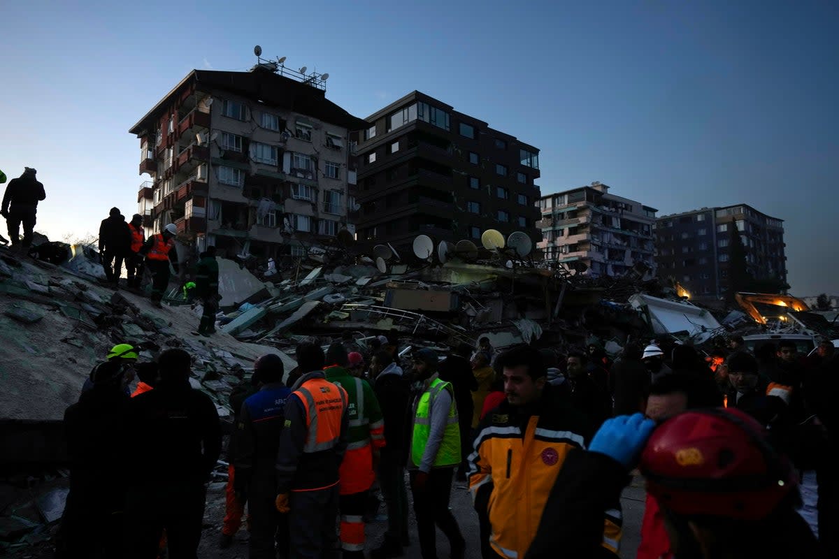 Rescue teams search for people in the rubble of destroyed buildings in Antaky (Copyright 2023 The Associated Press. All rights reserved.)