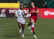 Jaz Gray, left, of the United States, runs for a try as Canada's Emma Chown chases during an HSBC Canada Sevens semifinal rugby match in Edmonton, Alberta, Sunday, Sept. 26, 2021. (Jason Franson/The Canadian Press via AP)