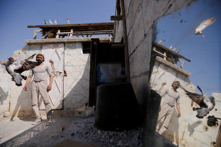 Abu Nimr, 36, stands near his pigeons in Yarmouk Palestinian camp in Damascus, Syria October 10, 2018. Picture taken October 10, 2018. REUTERS/Omar Sanadiki