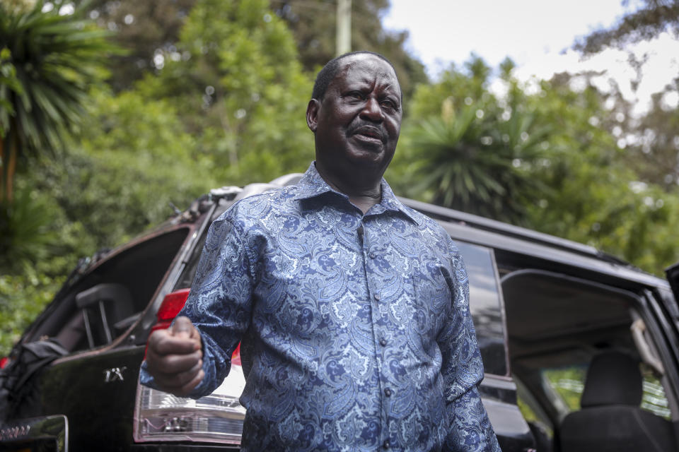 Kenya's opposition leader Raila Odinga speaks next to one of his vehicles he says was struck by a teargas canister fired by riot police, at his home in Nairobi, Kenya Friday, March 31, 2023. In an interview with The Associated Press on Friday, Odinga denounced the point-blank firing of a tear gas canister at local journalists during his latest anti-government protest as a "primitive act of intolerance" and vowed to go to court over what he called an attempt on his own life. (AP Photo/Brian Inganga)
