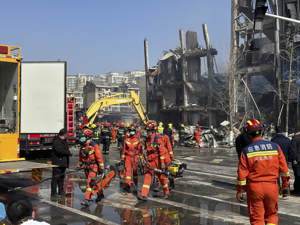 FILE - Firefighters work the scene of an explosion in Sanhe city in northern China's Hebei province on Wednesday, March 13, 2024. The city of Sanhe, near Beijing, issued a public apology Thursday, March 14, after authorities were shown harassing reporters from state broadcaster CCTV during a live broadcast near the site of a suspected gas leak explosion that killed several and injured more than 20 on Wednesday.(AP Photo/Ng Han Guan, File)