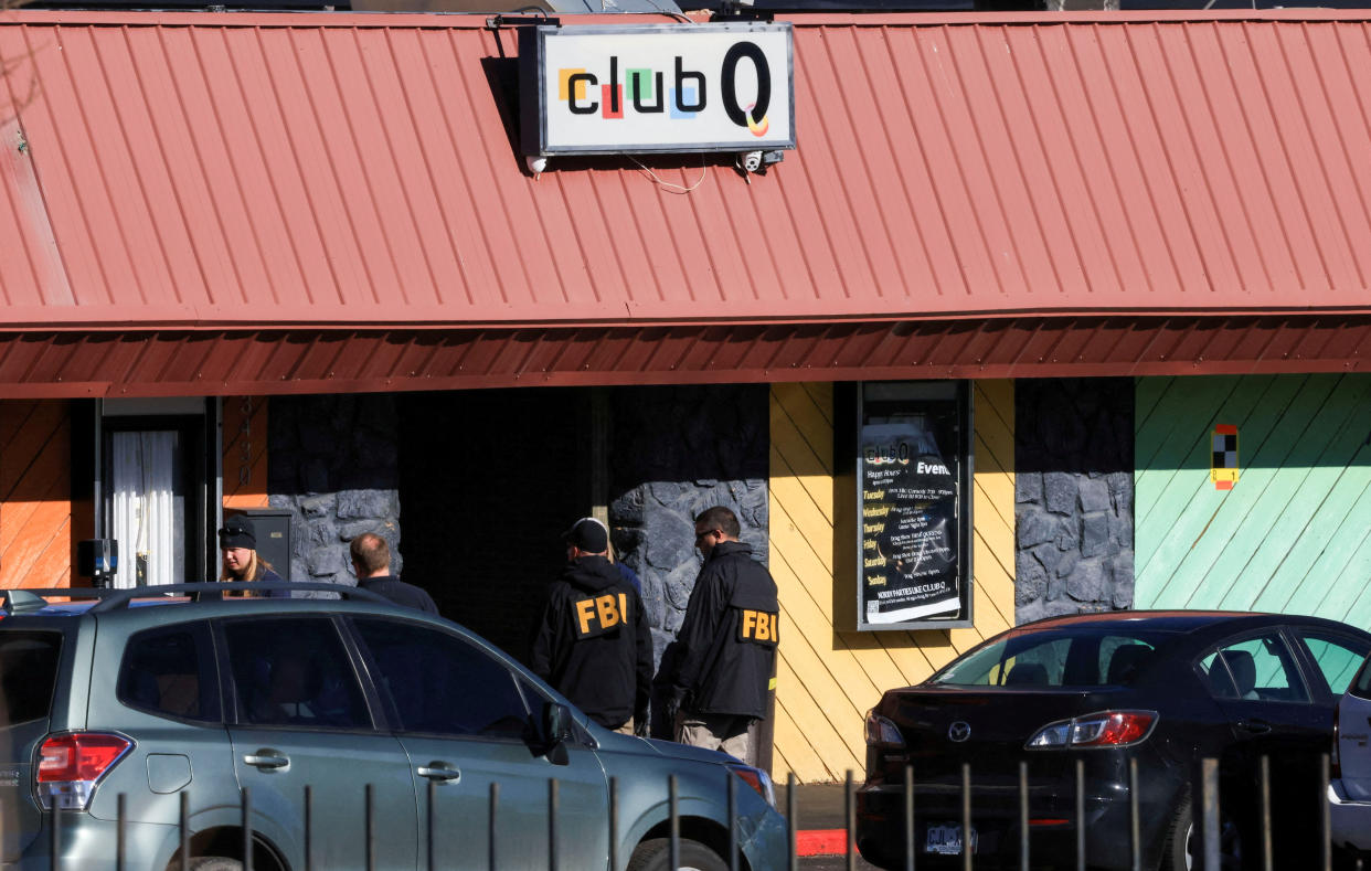 Two men in jacket marked FBI stand outside the Club Q in Colorado Springs, Colo., on Monday. (Kevin Mohatt/Reuters)