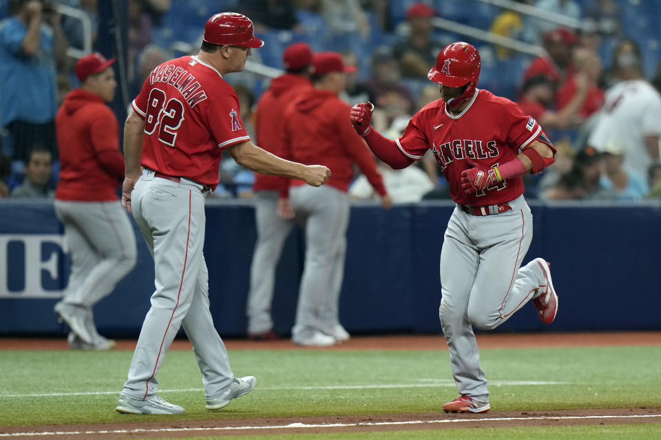 Los Angeles Angels' Logan O'Hoppe (14) celebrates with third base coach Bill Haselman (82) after his solo home run off Tampa Bay Rays starting pitcher Taj Bradley during the fourth inning of a baseball game Tuesday, Sept. 19, 2023, in St. Petersburg, Fla. (AP Photo/Chris O'Meara)