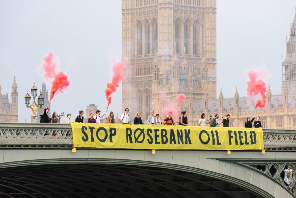 London, UK. 4 September 2023. Fossil Free London campaign to stop Rosebank, the largest proposed new oil field in the North Sea. The activists unveil a massive protest banner on Westminster Bridge on the first day MPs return back to Parliament after summer recess. Credit: Andrea Domeniconi/Alamy Live News