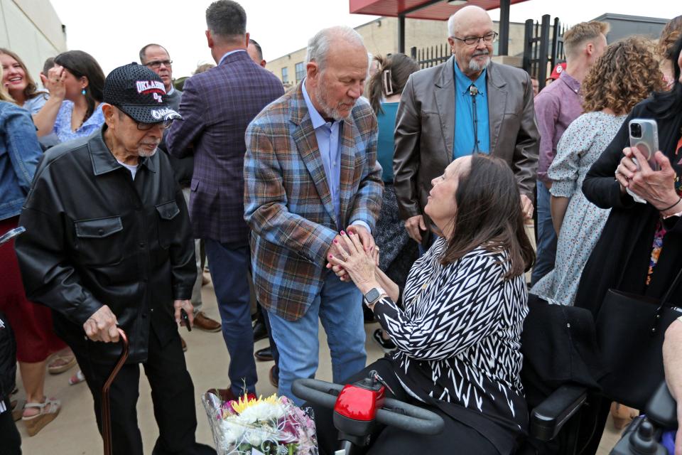 Former OU football coach Barry Switzer talks with Jan Kalsu, Robert Kalsu's widow, on Friday. Switzer called Bob Kalsu "the best player we had."