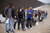 Migrants who had crossed the Rio Grande river into the U.S. wait to be processed by Border Patrol agents in Eagle Pass, Texas, Friday, May 20, 2022. As U.S. officials anxiously waited, many of the migrants crossing the border from Mexico on Friday were oblivious to a pending momentous court ruling on whether to maintain pandemic-related powers that deny a chance to seek asylum on grounds of preventing the spread of COVID-19. (AP Photo/Dario Lopez-Mills)