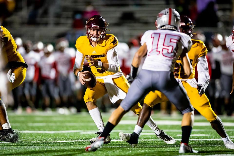 New Hampsted quarterback Pauly Seeley scambles looking to make a play in a 2021 game against Jenkins.