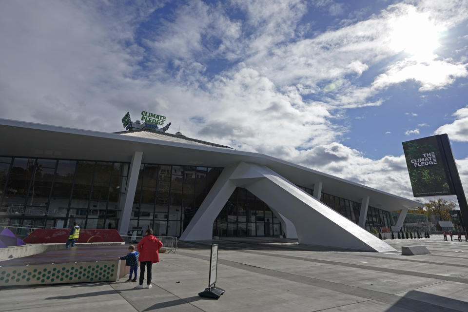 The sun shines above Climate Pledge Arena, Wednesday, Oct. 20, 2021, ahead of the NHL hockey Seattle Kraken's home opener Saturday against the Vancouver Canucks in Seattle. The historic angled roof of the former KeyArena was preserved, but everything else inside the venue, which will also host concerts and be the home of the WNBA Seattle Storm basketball team, is brand new. (AP Photo/Ted S. Warren)