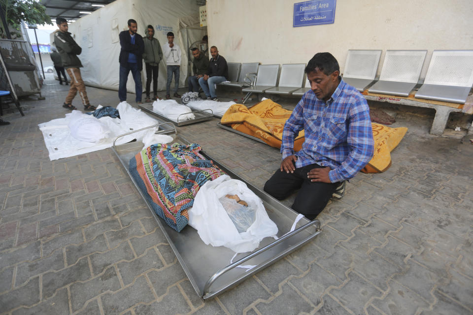 Palestinians mourn over the bodies of relatives killed in the Israeli bombardment of the Gaza Strip in Rafah on Friday, Nov. 17, 2023. (AP Photo/Hatem Ali)