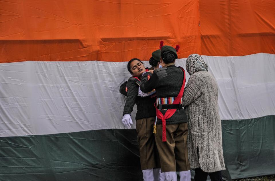 Cadets of the National Cadet Corps (NCC) attend to a unconscious who fainted after a Republic Day parade in Srinagar, Indian controlled Kashmir, Thursday, Jan. 26 , 2023. (AP Photo/Mukhtar Khan)