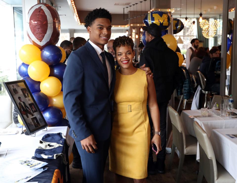 Kumasi Kumasi, right, mother of Grosse Pointe South senior Will Johnson, left, who committed to play football at Michigan on Wednesday, Dec. 15, 2021, at a ceremony held at the Parc restaurant at Campus Martius.