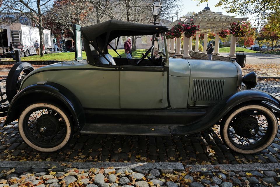 Vintage cars are parked on the side of Acushnet Avenue as filming continues on a TV series, 'Invitation to a Bonfire,' set in the 1930s being filmed in downtown New Bedford.