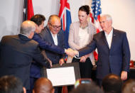 Papua New Guinea's Prime Minister Peter O' Neill shakes hands with U.S. Vice President Mike Pence as Australia's Prime Minister Scott Morrison, New Zealand's Prime Minister Jacinda Ardern and Japan's Prime Minister Shinzo Abe look on, during the signing of a joint electricity deal between Australia, Japan, New Zealand, United States for Papua New Guinea, during the APEC Summit in Port Moresby, Papua New Guinea November 18, 2018. REUTERS/David Gray